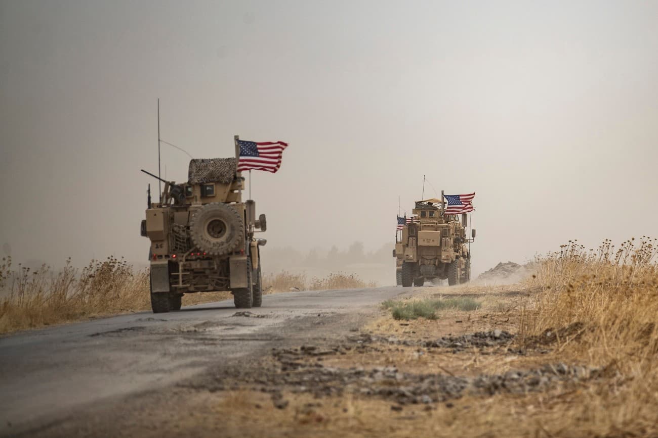U.S. military vehicles drive in the vicinity of an oil field in Rumaylan amid a sandstorm in Syria’s Kurdish-controlled northeastern Hasakeh Province.