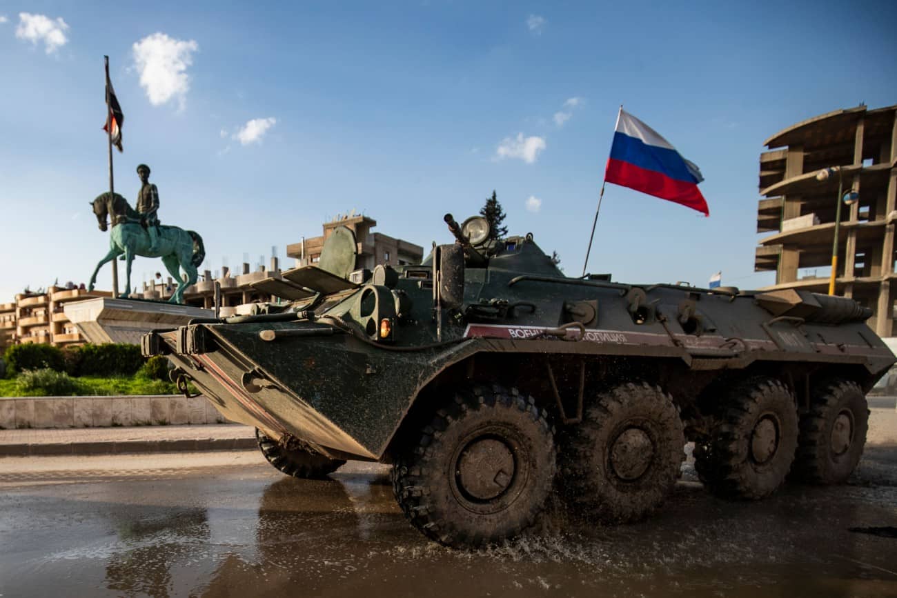 A Russian military police armored infantry vehicle returning from a joint patrol with Turkish forces along the Syrian-Turkish border, drives along a roundabout near Qamishli airport.