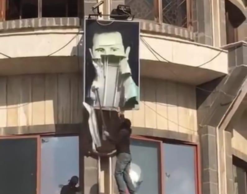 Picture of Assad's poster being torn down