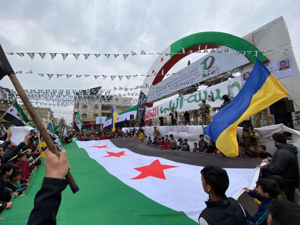 17 March: Protesters in al-Bab, northern Syria, raise the Ukrainian flag in solidarity with their fight for freedom.
